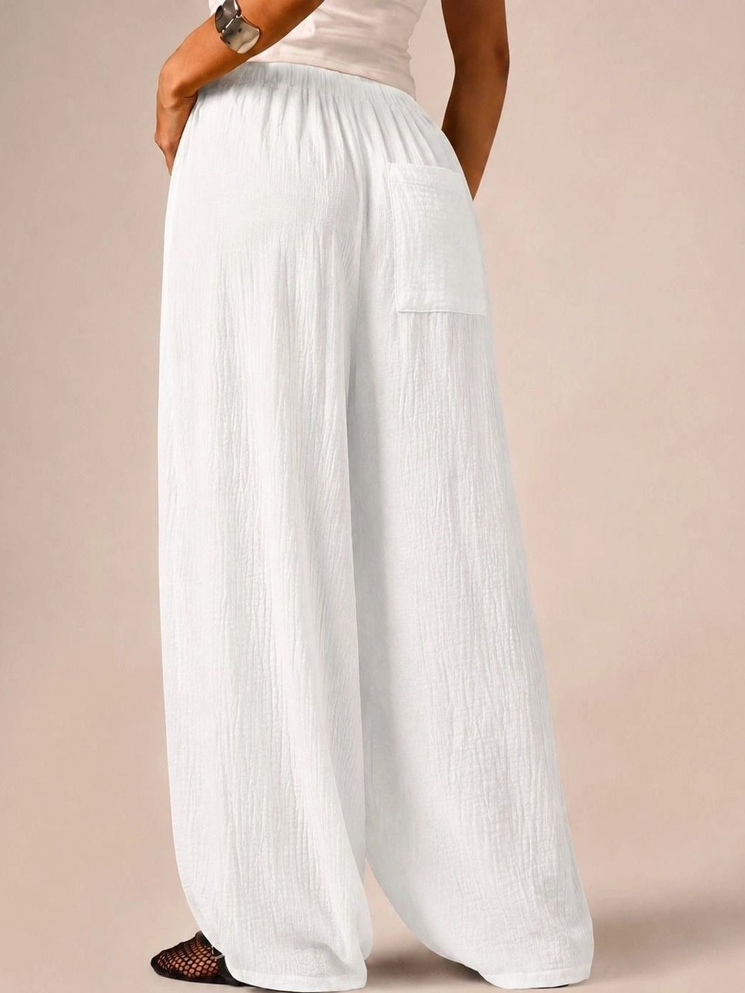 White textured wide-leg track pants — back view