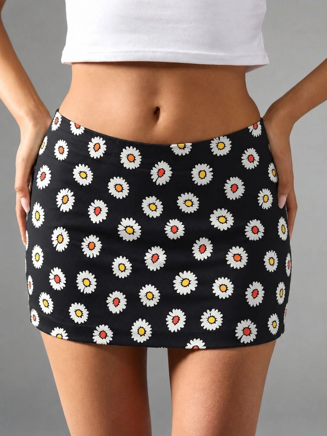 Daisy Pop Black Cotton Mini Skirt — close-up of white daisies with yellow and orange centres