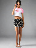 Daisy Pop Black Cotton Mini Skirt with white daisy print — full front view