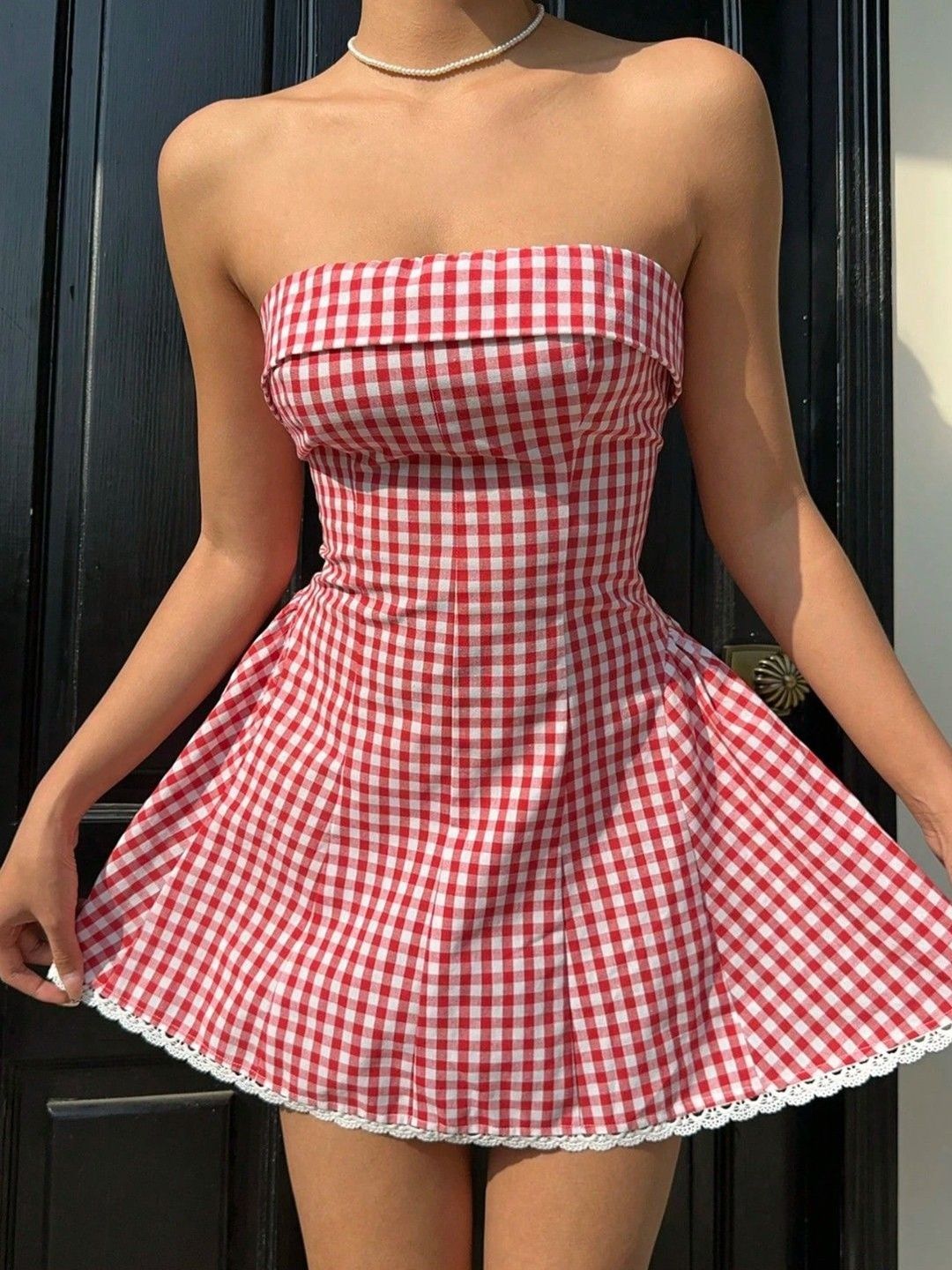 Red gingham mini dress with flared skirt and white ruffled trim