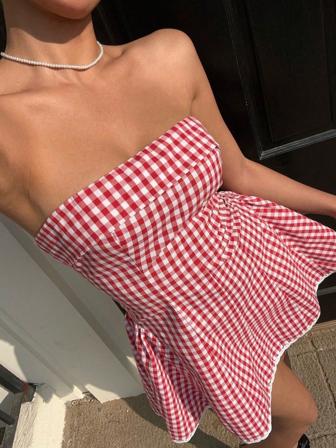 Close-up of red and white check strapless dress bodice
